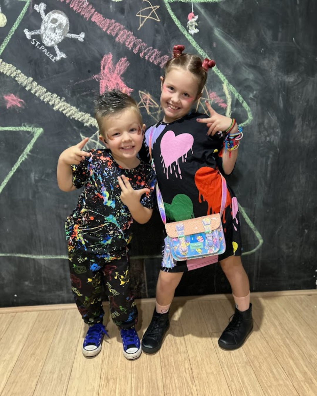 Two children in bright clothes with colour Two children in bright clothes with colour