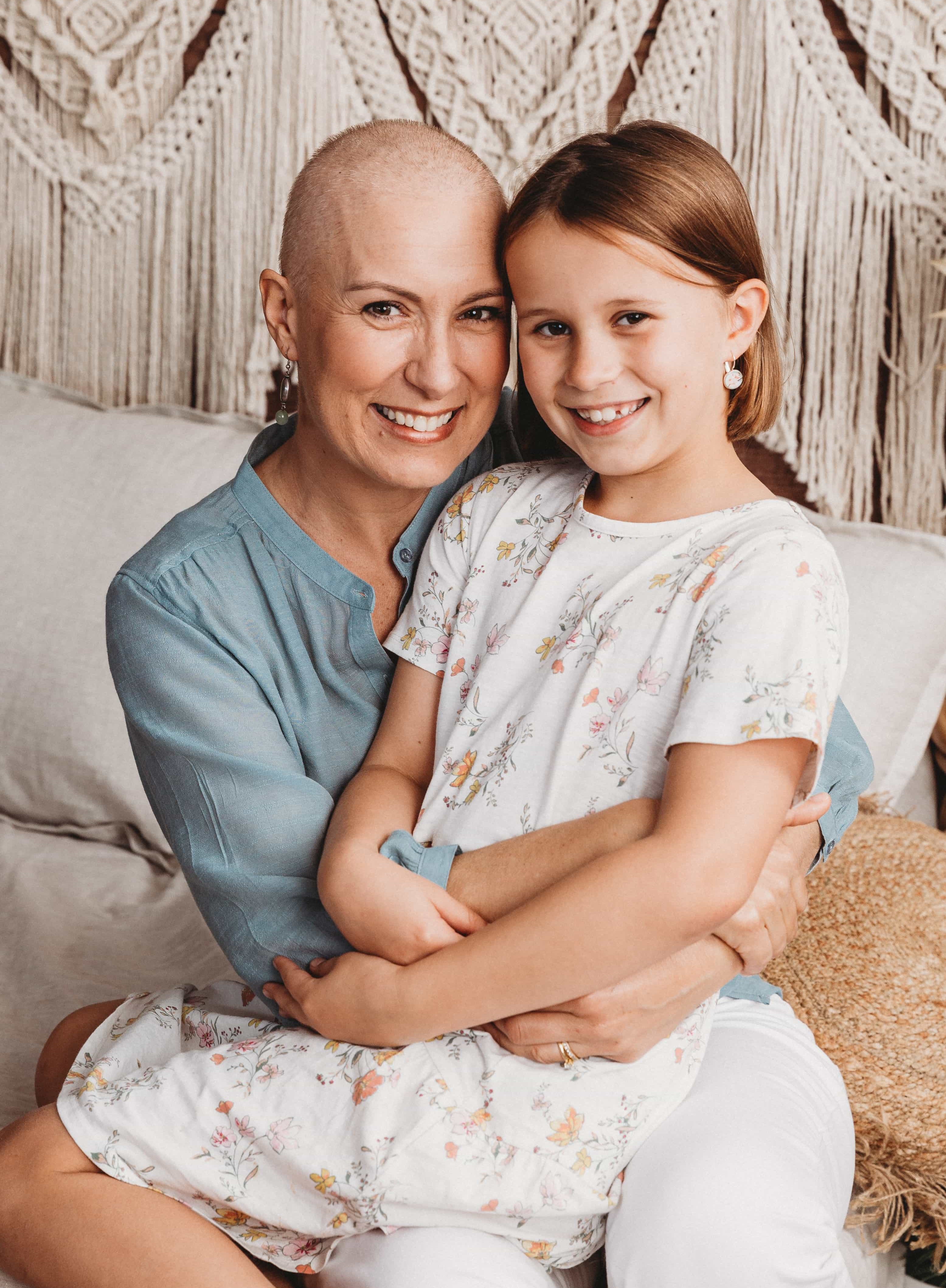 Woman with breast cancer holding daughter Woman with breast cancer holding daughter