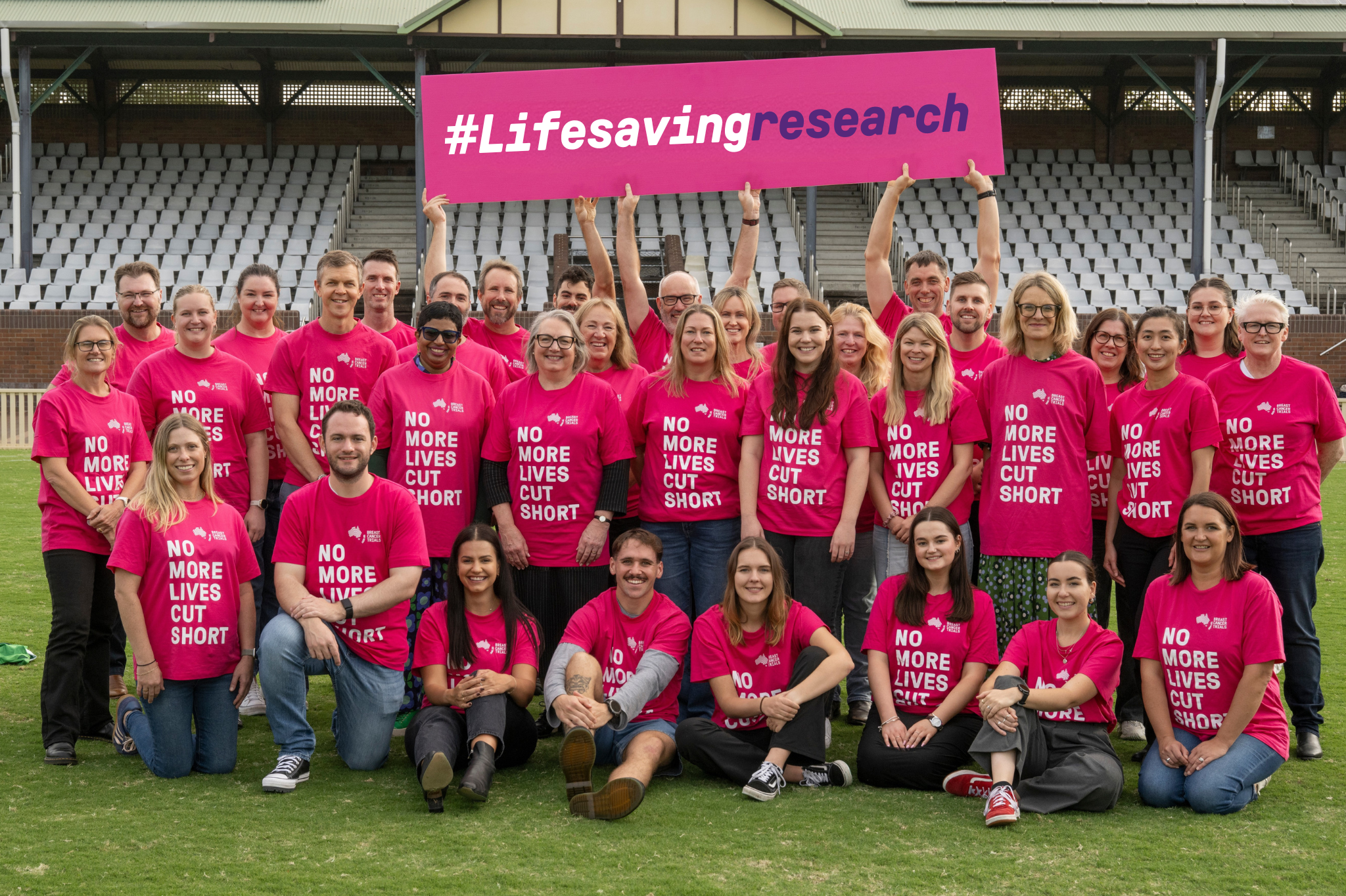 People wearing matching pink shirts saying no more lives cut short People wearing matching pink shirts saying no more lives cut short