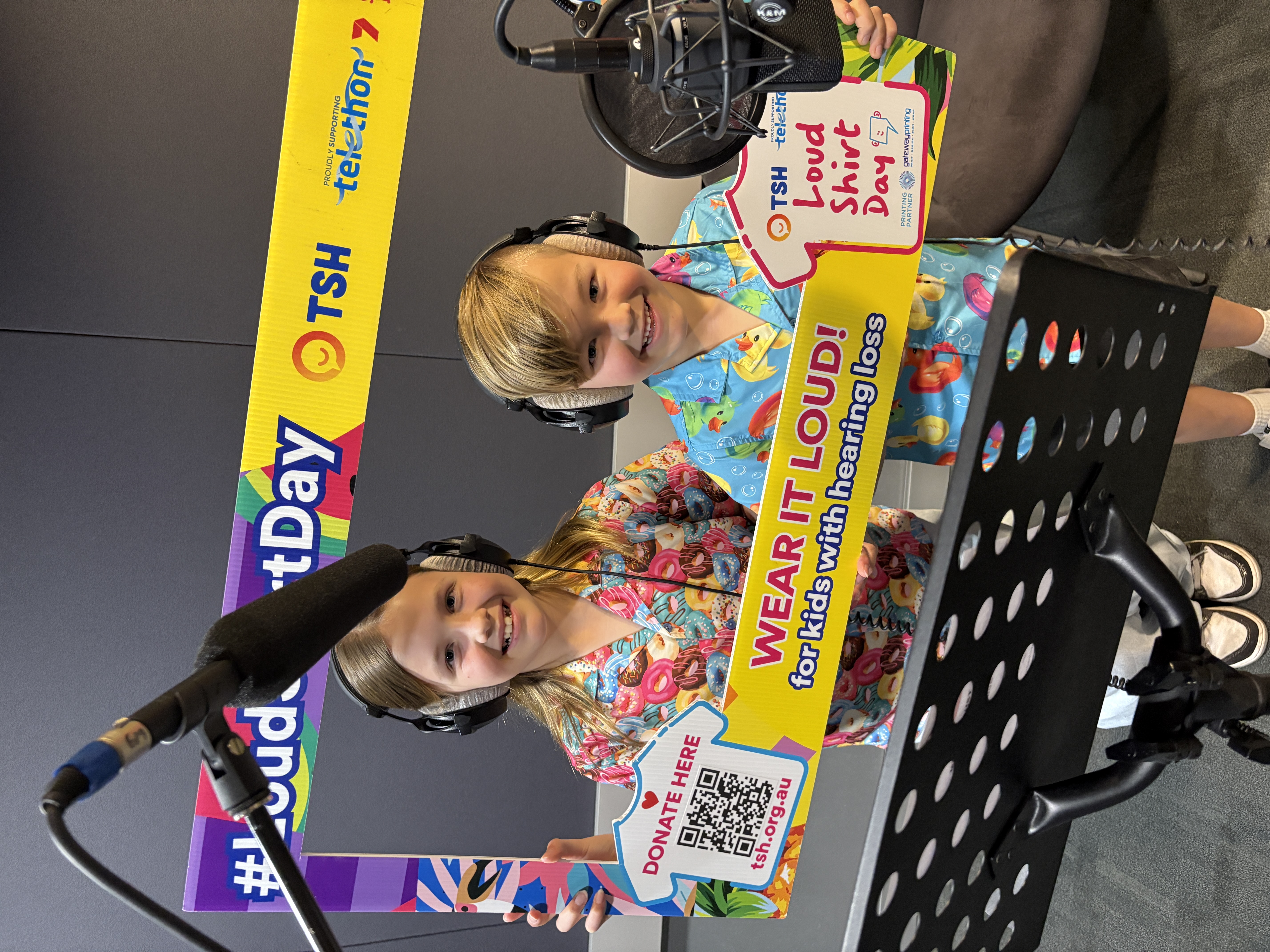 Two children in loud shirts inside a radio studio Two children in loud shirts inside a radio studio